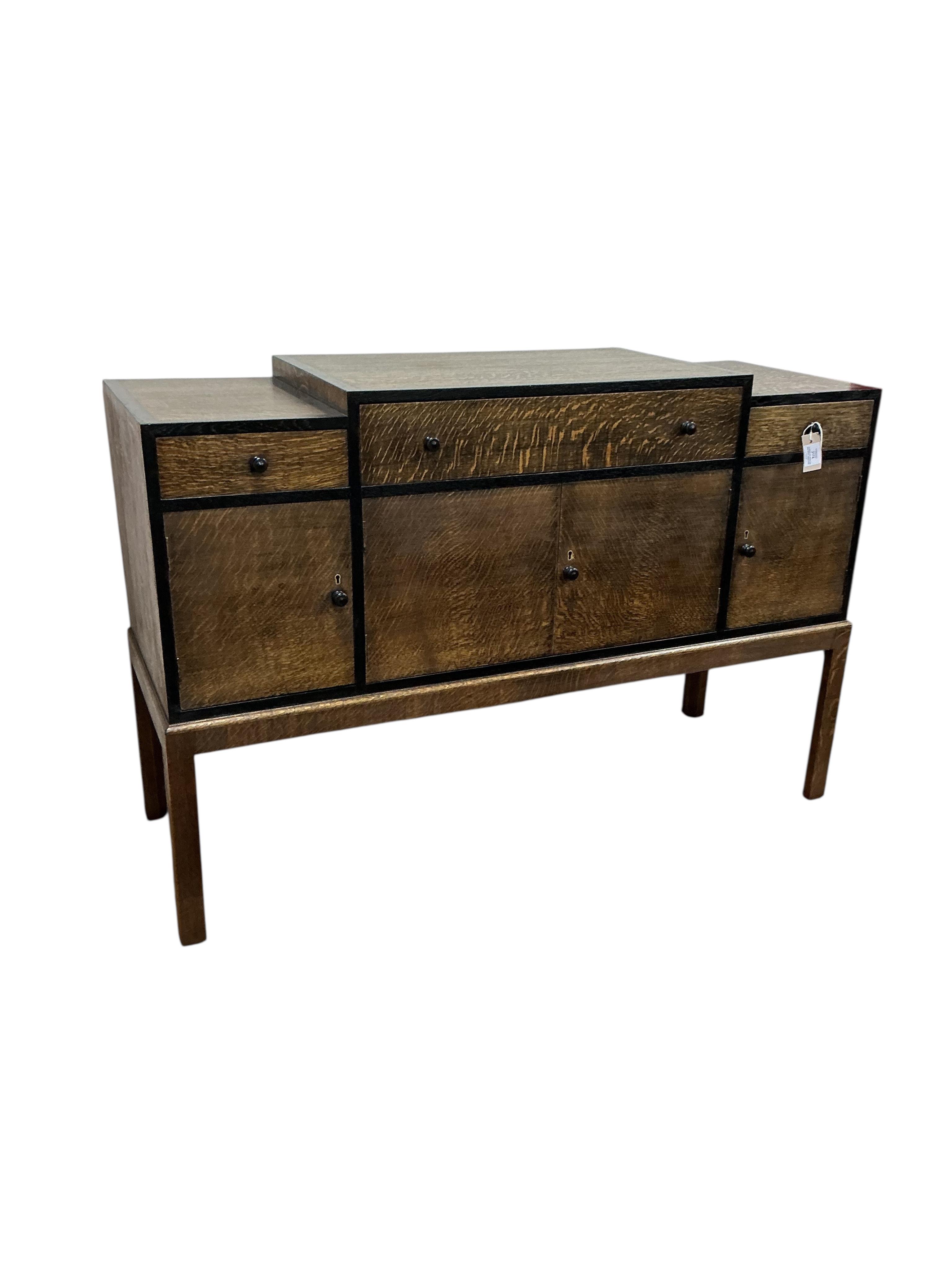 A Heals Art Deco oak and ebony sideboard, width 137cm, depth 49cm, height 92cm.